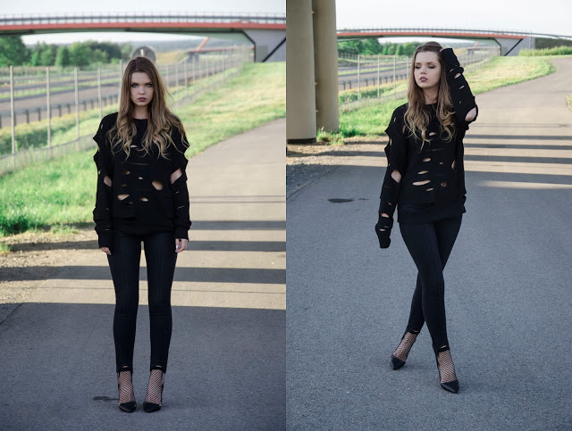 The world is my runway.: Cut out black sweater.